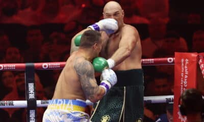 Tyson Fury dodging a punch from Oleksandr Usyk during their heavyweight boxing rematch.