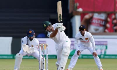 South African batsman in action during a Test match, playing a shot with a straight bat while a Sri Lankan wicketkeeper and slip fielder watch intently, in a game of cricket at St George's Park, Gqeberha.